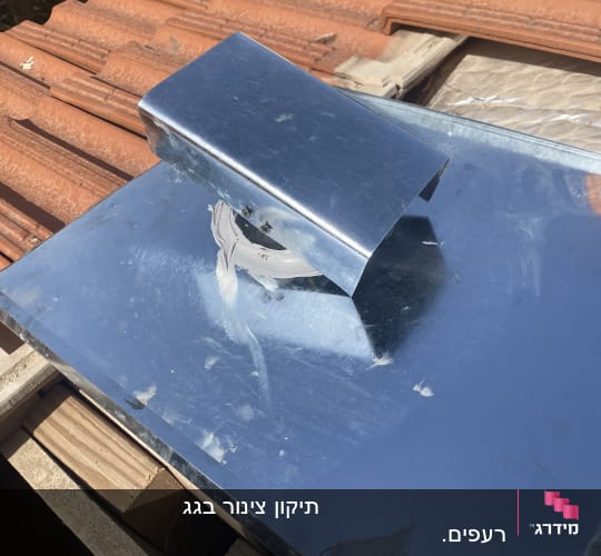 תמונה של גג רעפים עם חלק מתכת מותקן